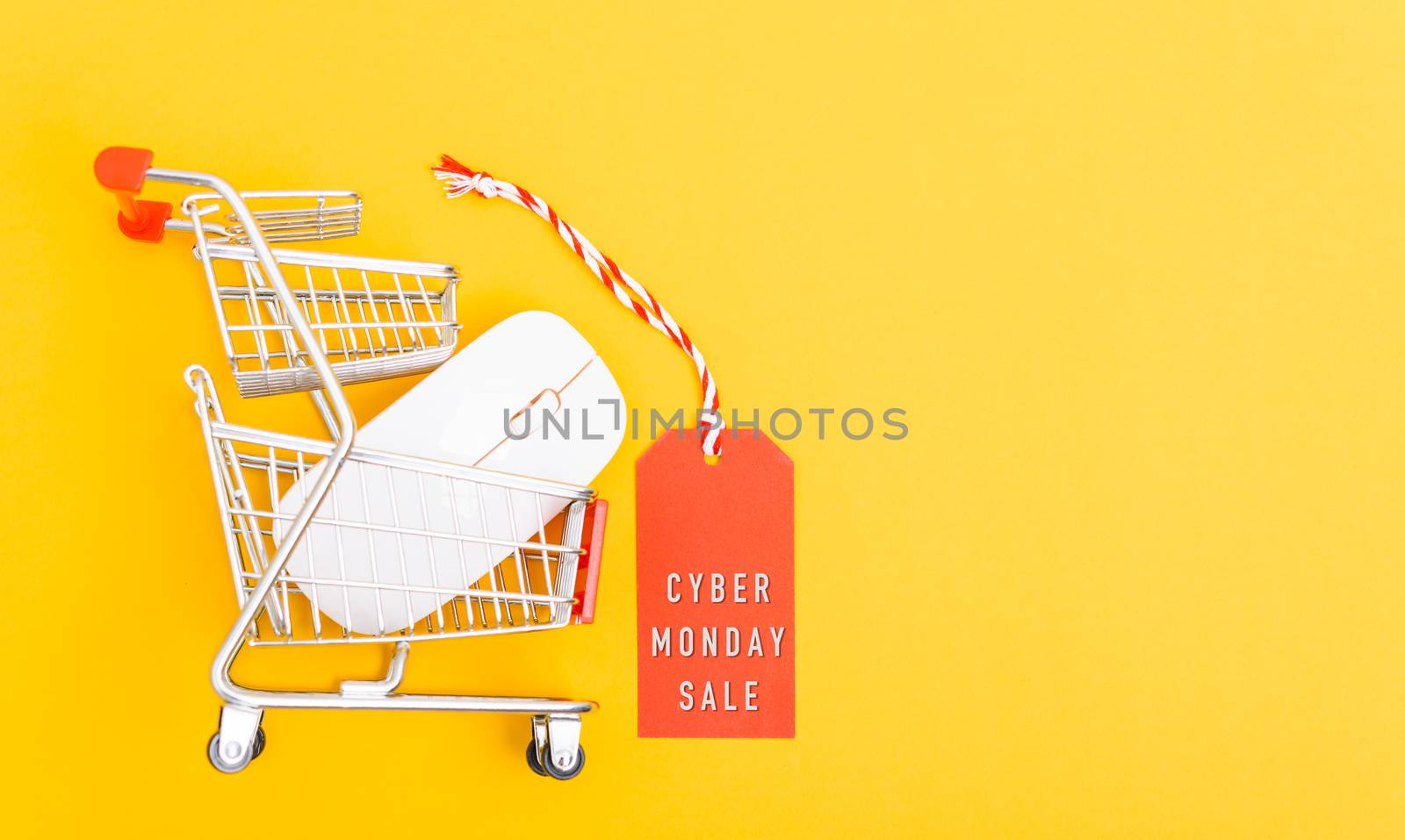 Online shopping Cyber Monday sale text on red tag label have white mouse on cart shopping, with copy space on yellow background