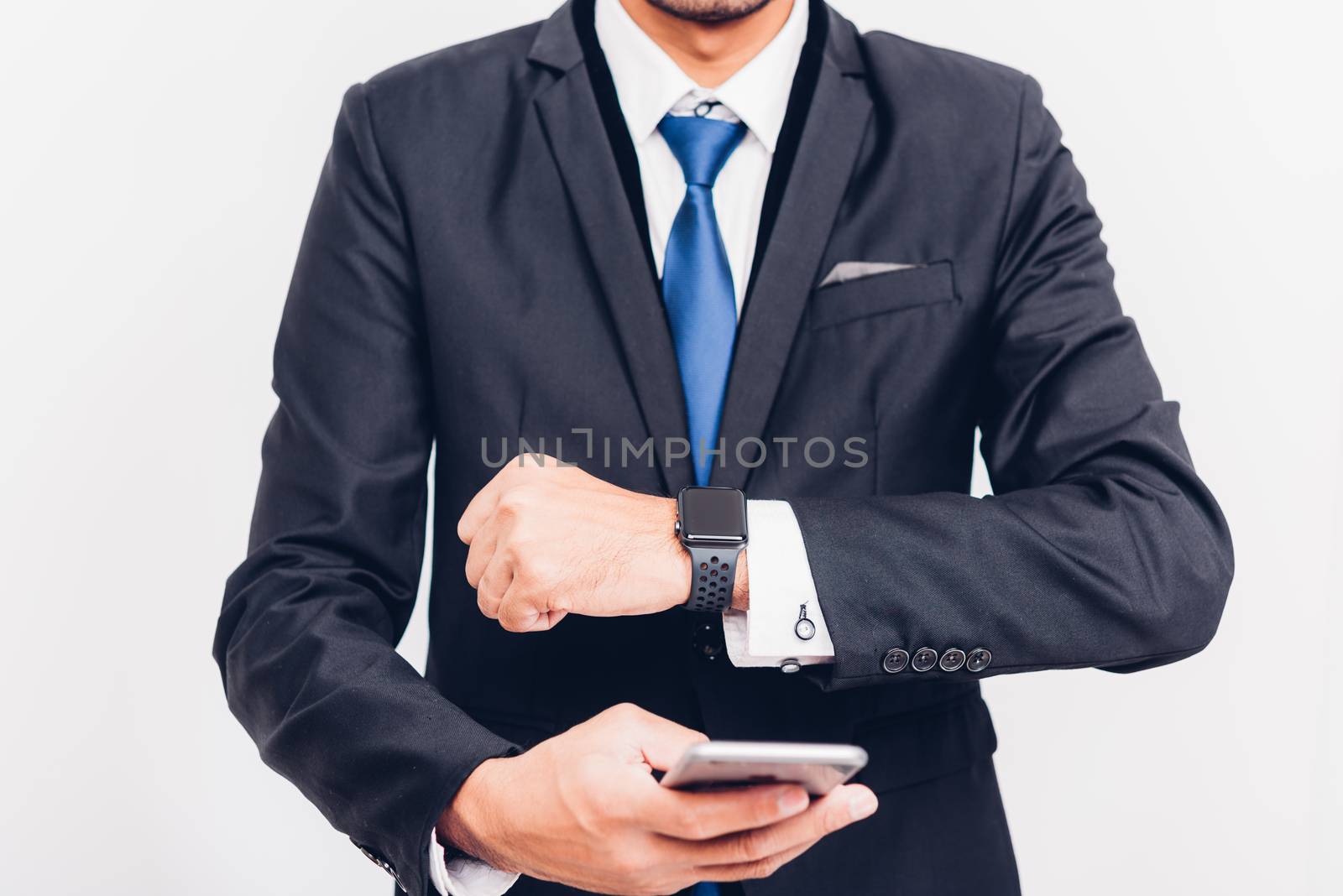 Business man wearable smart watch on hand and he is sync smarteatch to smartphone, the smart watch is modern technology design isolated on white background