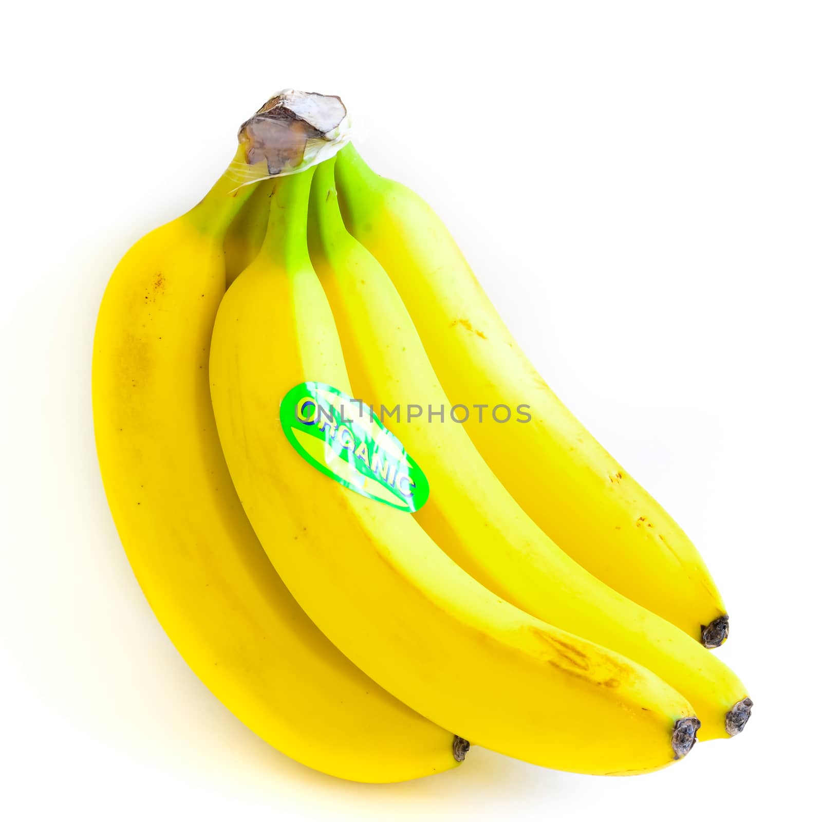 Close-up bright yellow banana cluster isolated on white background. Bunch of fresh bananas with organic label signage, clipping path and copy space