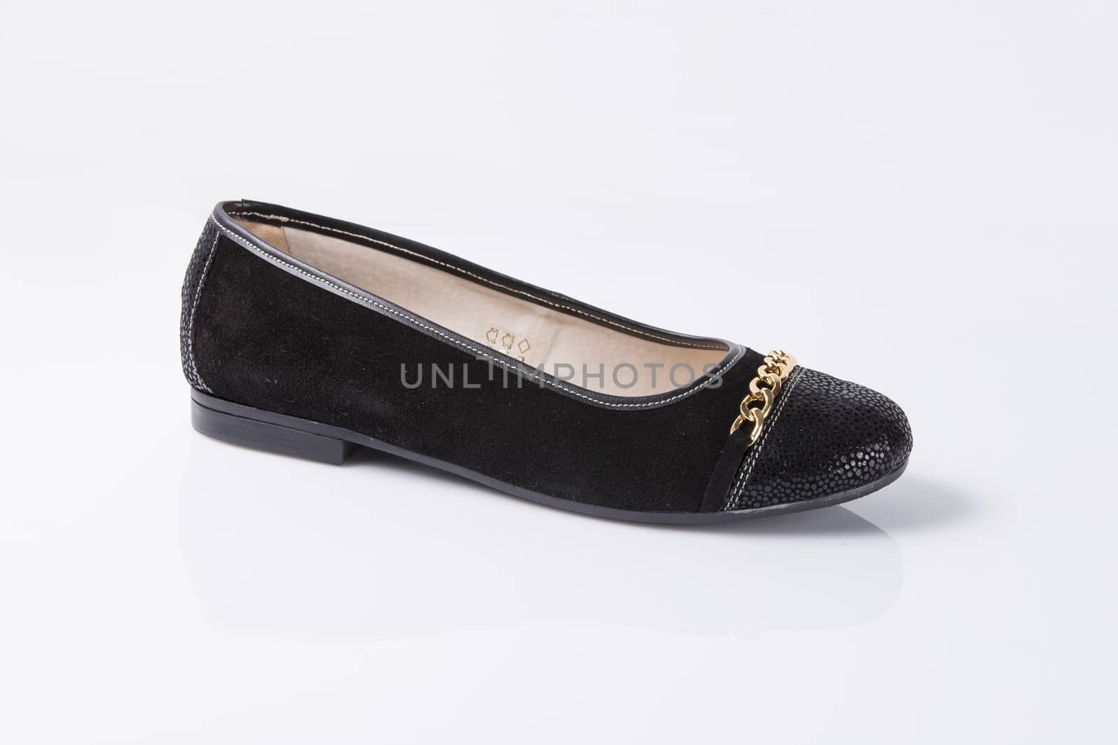 Female black leather shoe on white background, isolated product, top view.