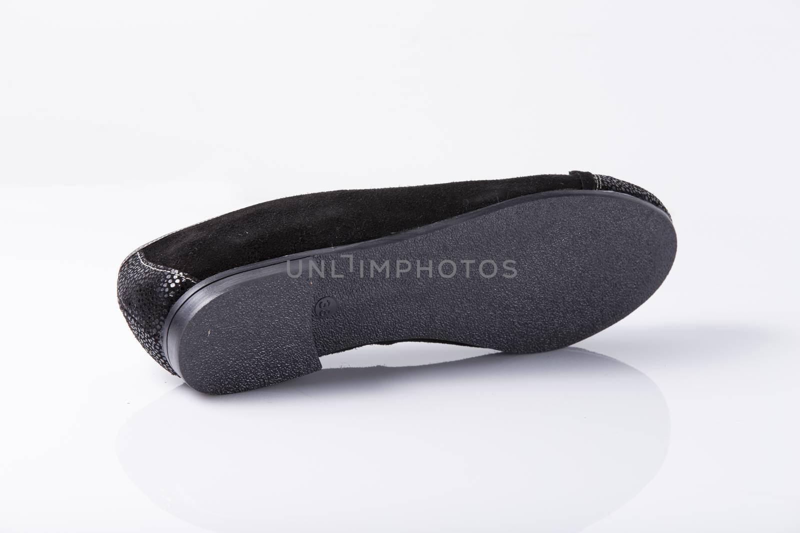 Female black leather shoe on white background, isolated product, top view. by GeorgeVieiraSilva