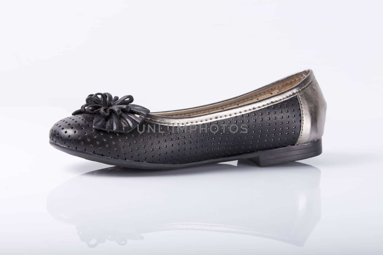 Female black leather shoe on white background, isolated product, top view. by GeorgeVieiraSilva