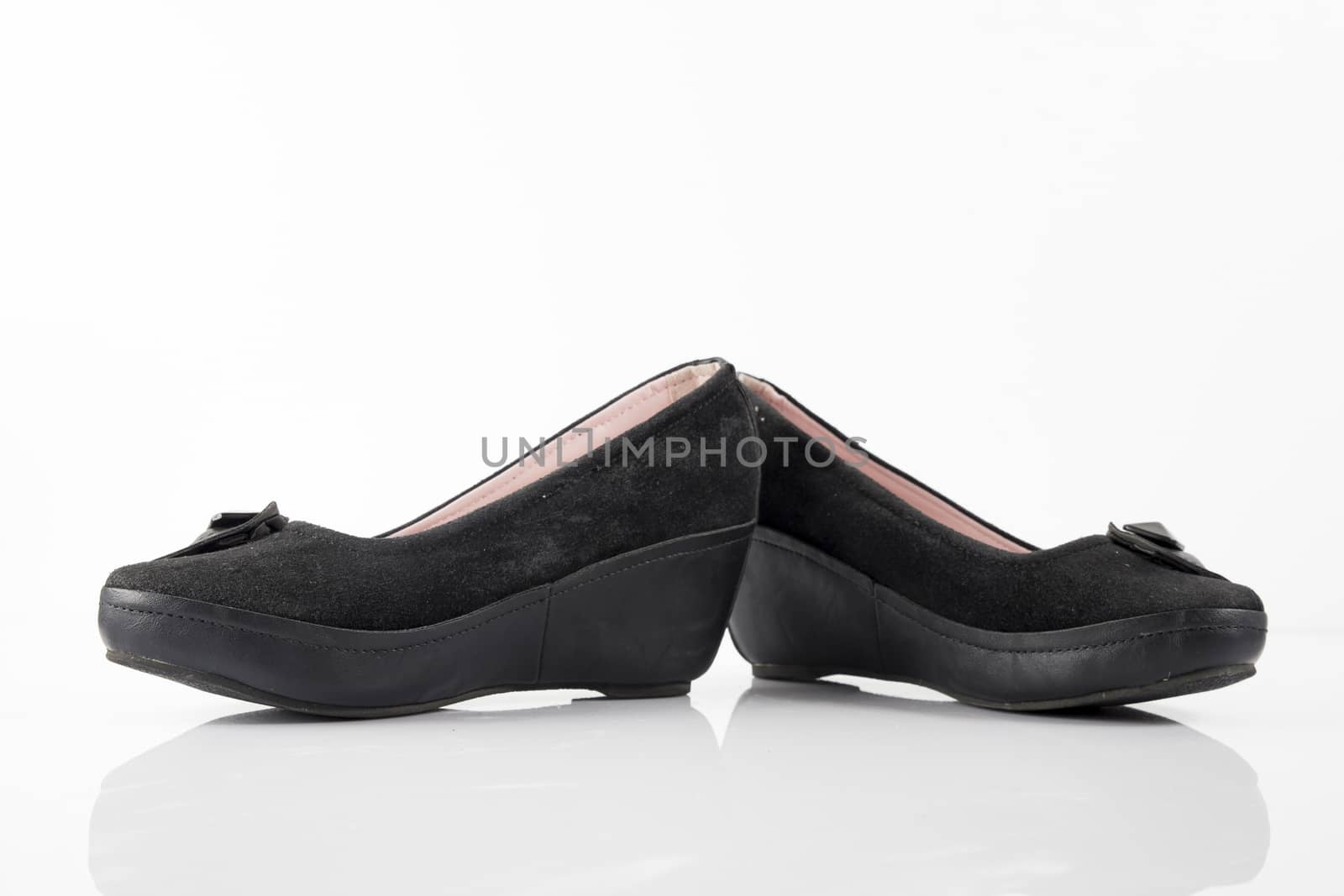 Female black leather shoe on white background, isolated product, top view. by GeorgeVieiraSilva