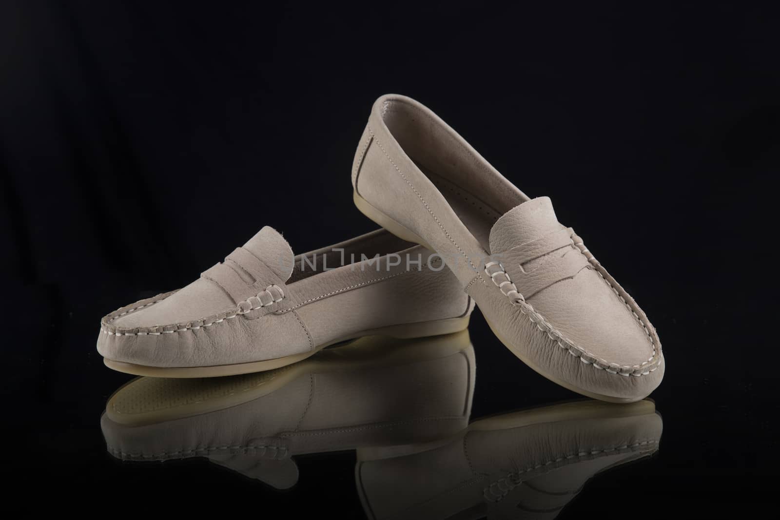 Pair of brown shoes on black background, isolated product.