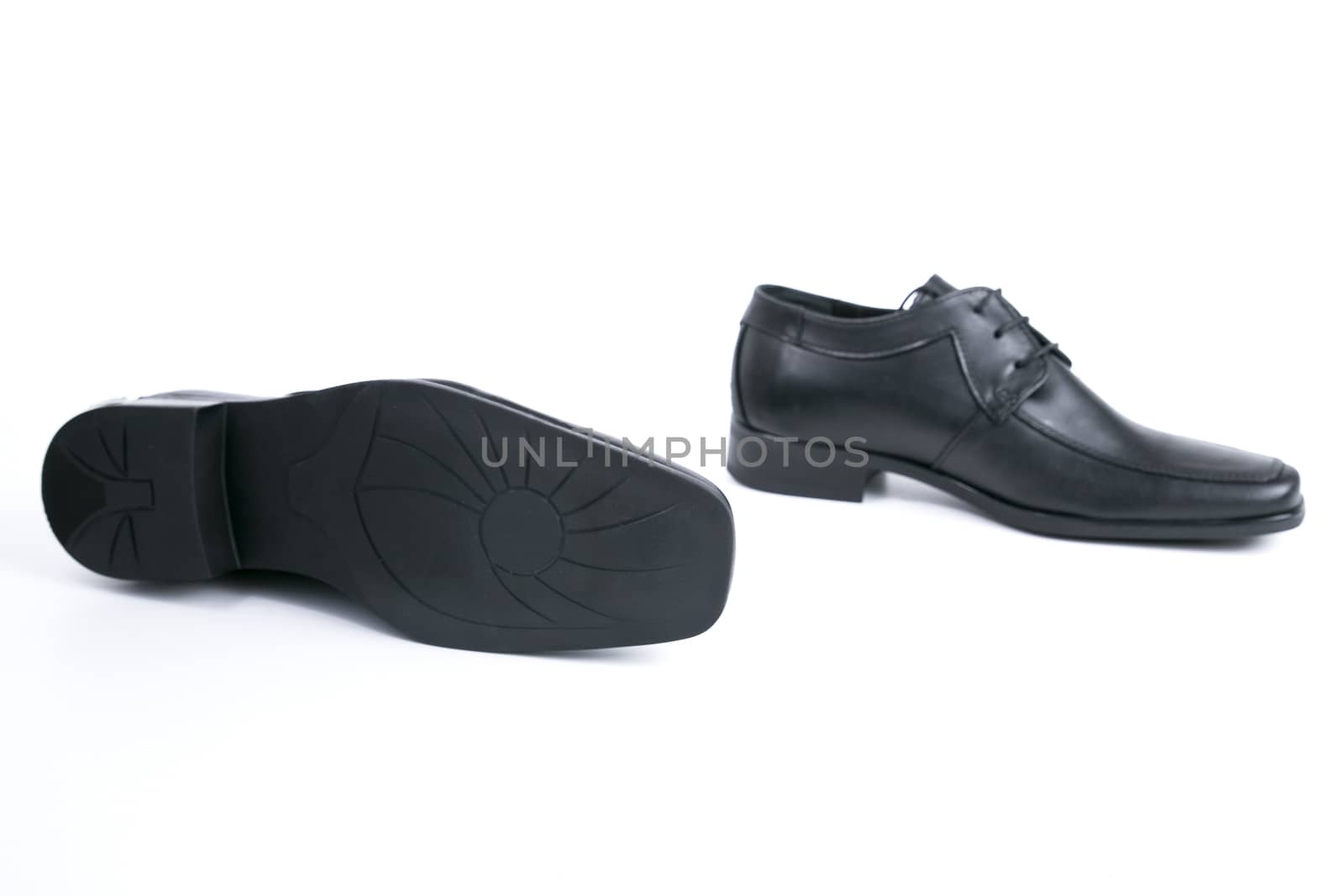 Pair of shoes on white background, top view.