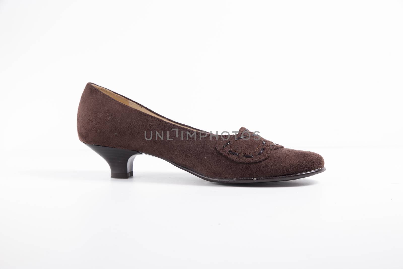 Female brown leather shoe on white background, isolated product. by GeorgeVieiraSilva