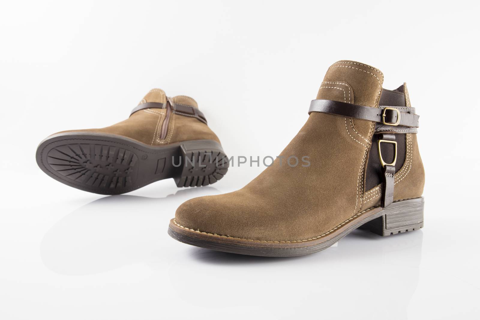 Pair of brown boots on white background, isolated product.