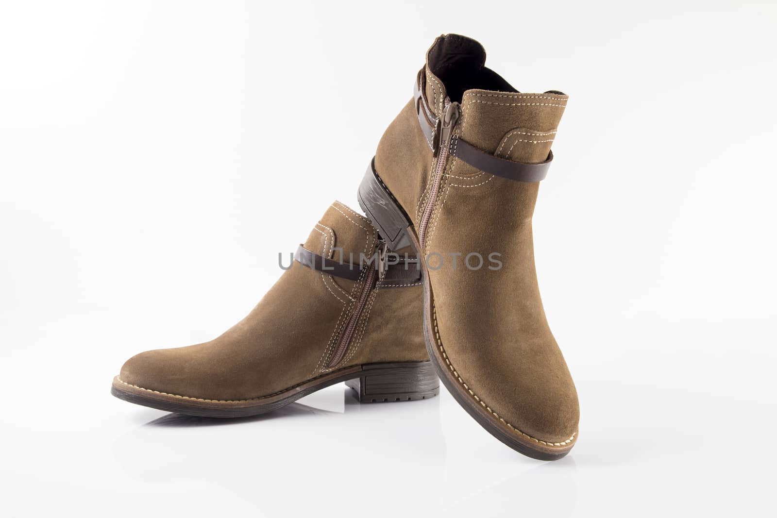 Female brown leather boot on white background, isolated product.