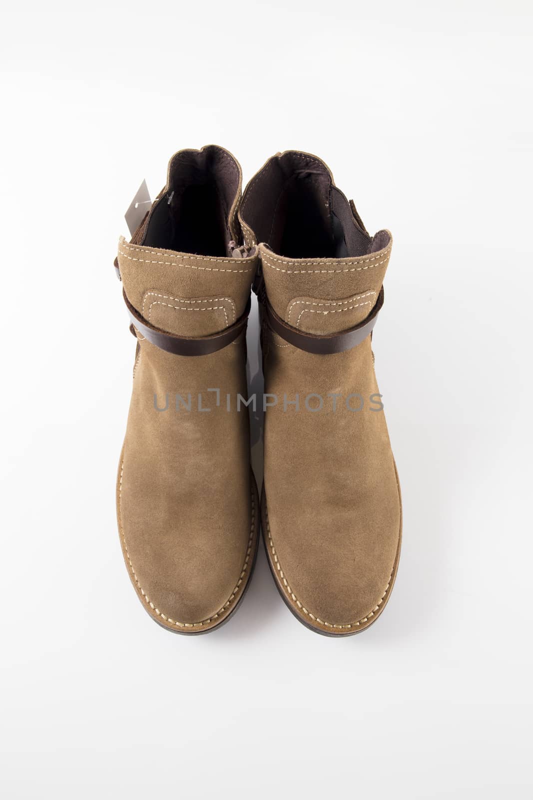 Female brown leather boot on white background, isolated product.