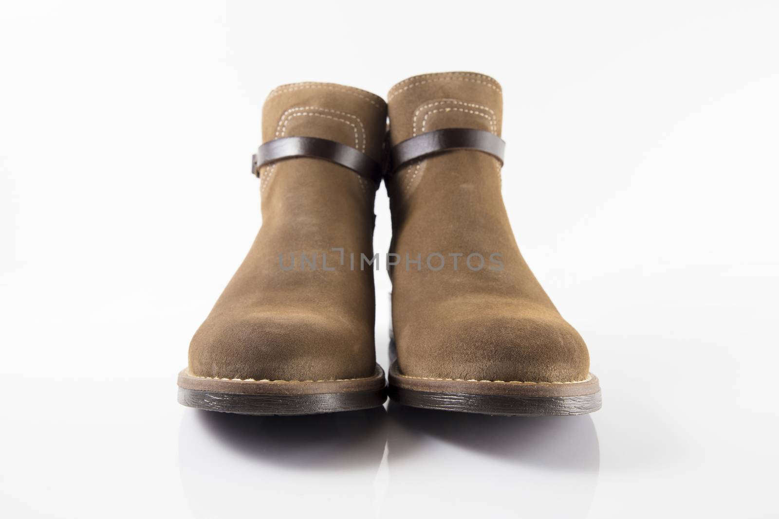 Pair of brown boots on white background, isolated product.