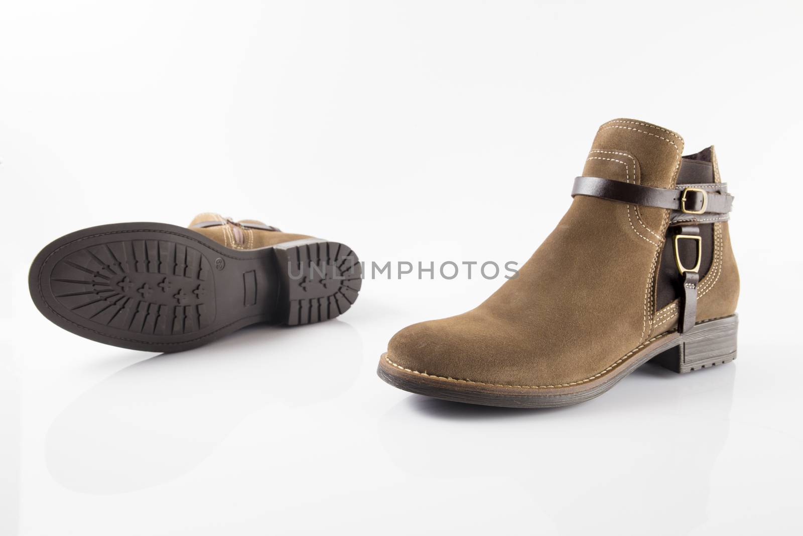 Pair of brown boots on white background, isolated product.