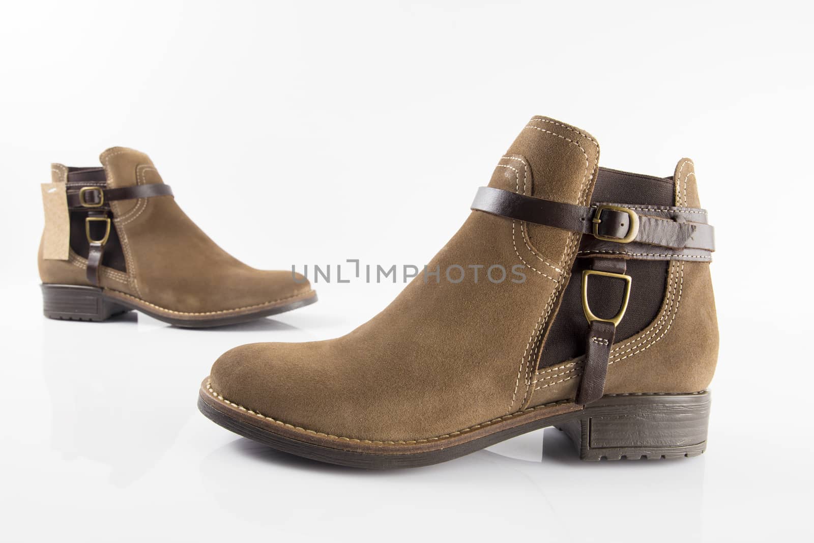 Female brown leather boot on white background, isolated product, top view.