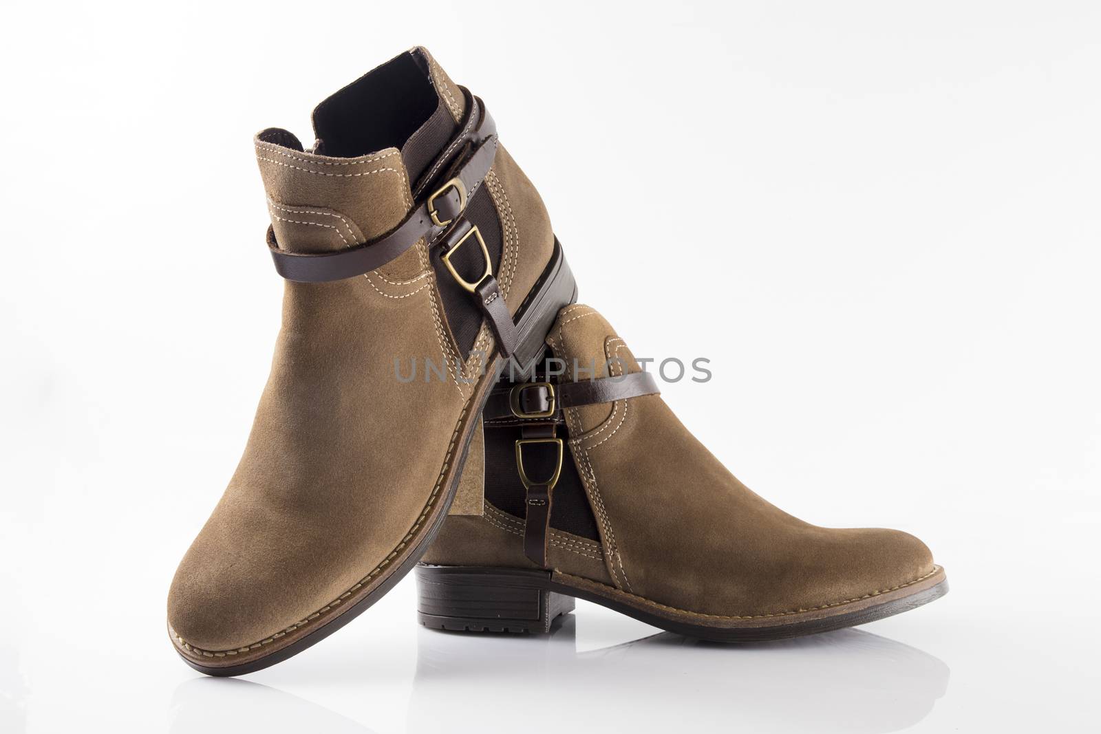 Female brown leather boot on white background, isolated product, top view.
