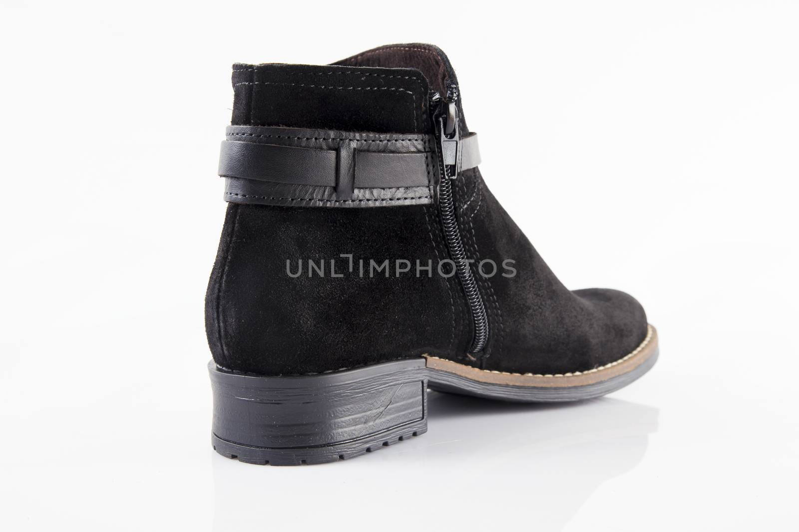 Female black leather boot on white background, isolated product, top view.