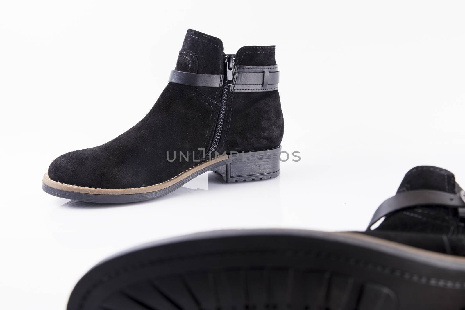 Pair of black boots on white background, isolated product.