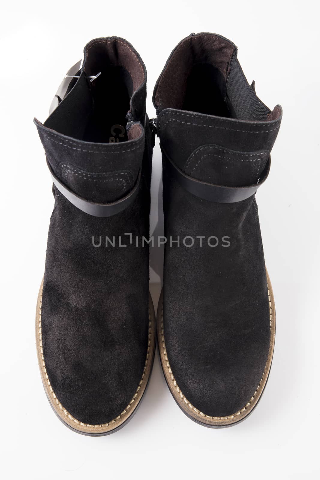 Female black leather boot on white background, isolated product, top view.