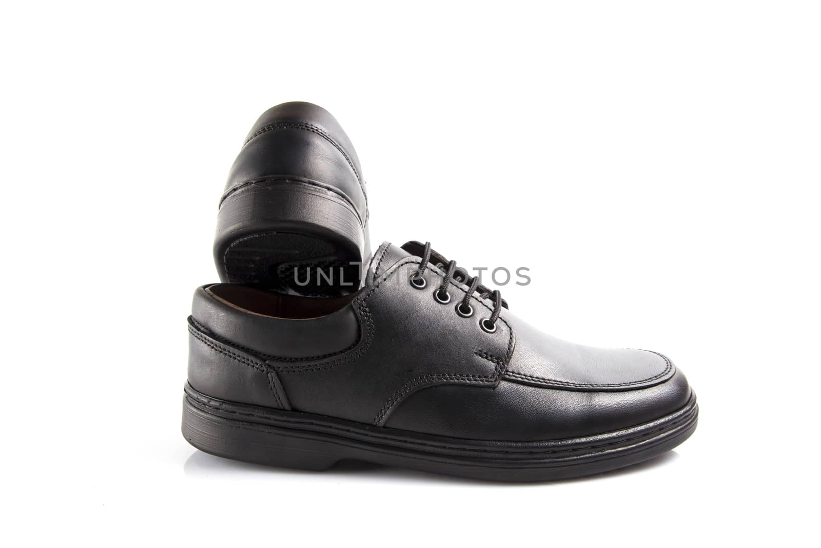 Pair of black leather shoes on white background, isolated product.