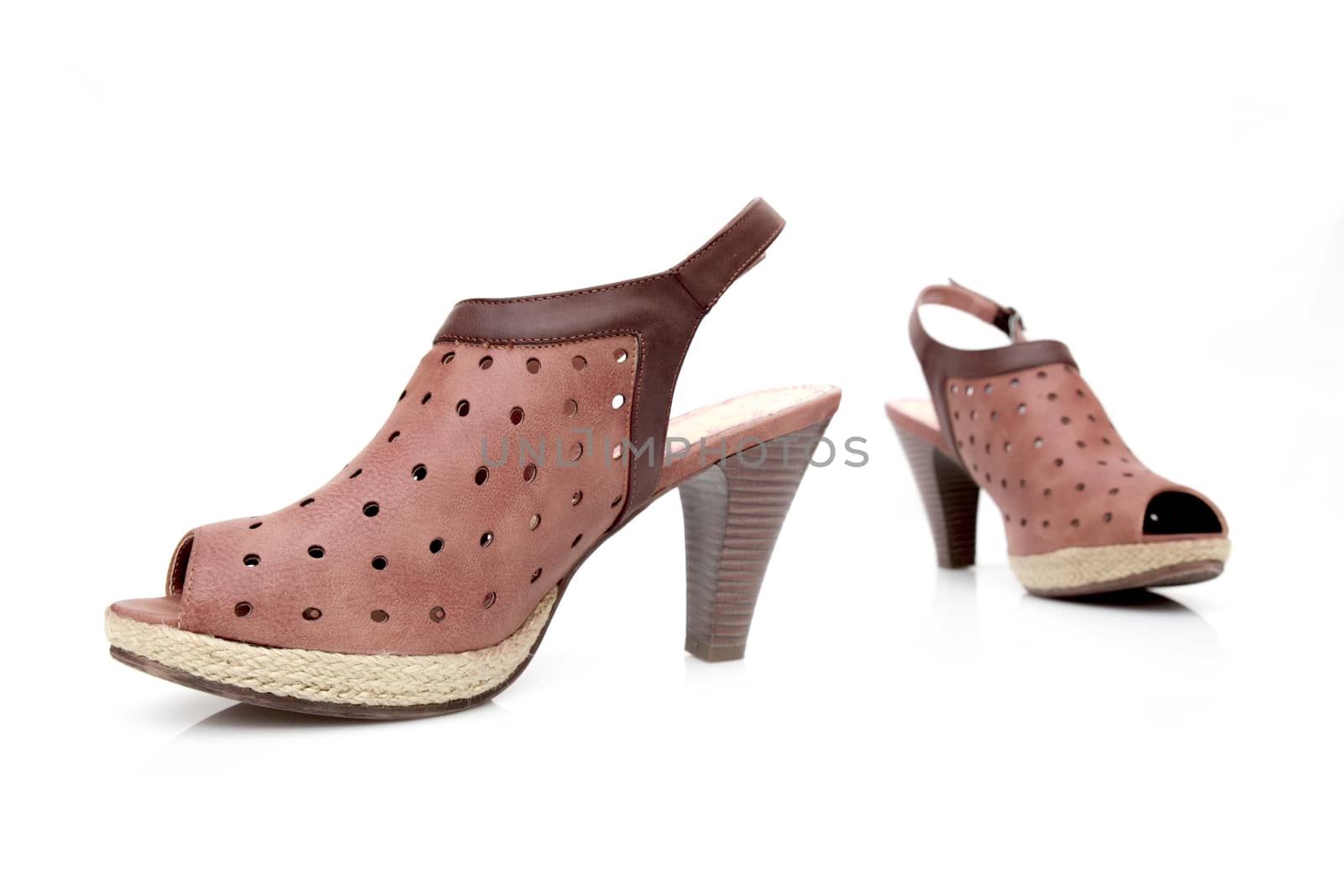 Female brown leather sandal on white background, isolated product.