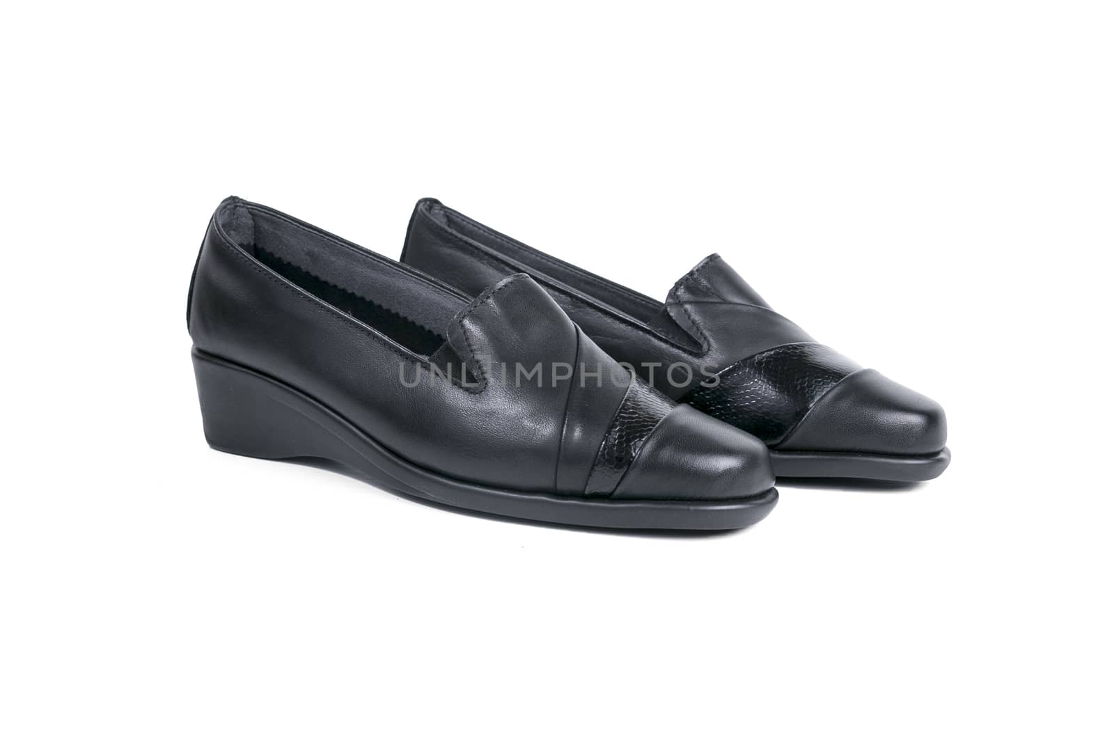 Pair of female black leather shoe on white background, isolated product.