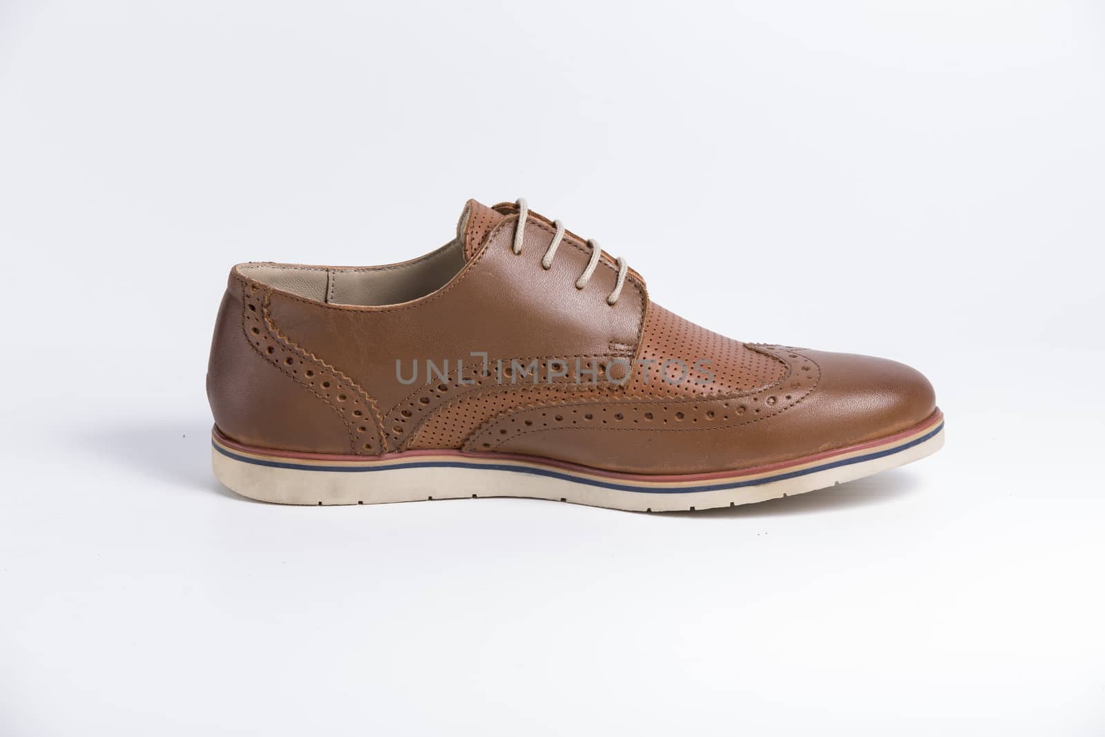 Male brown leather shoe on white background, isolated product. by GeorgeVieiraSilva