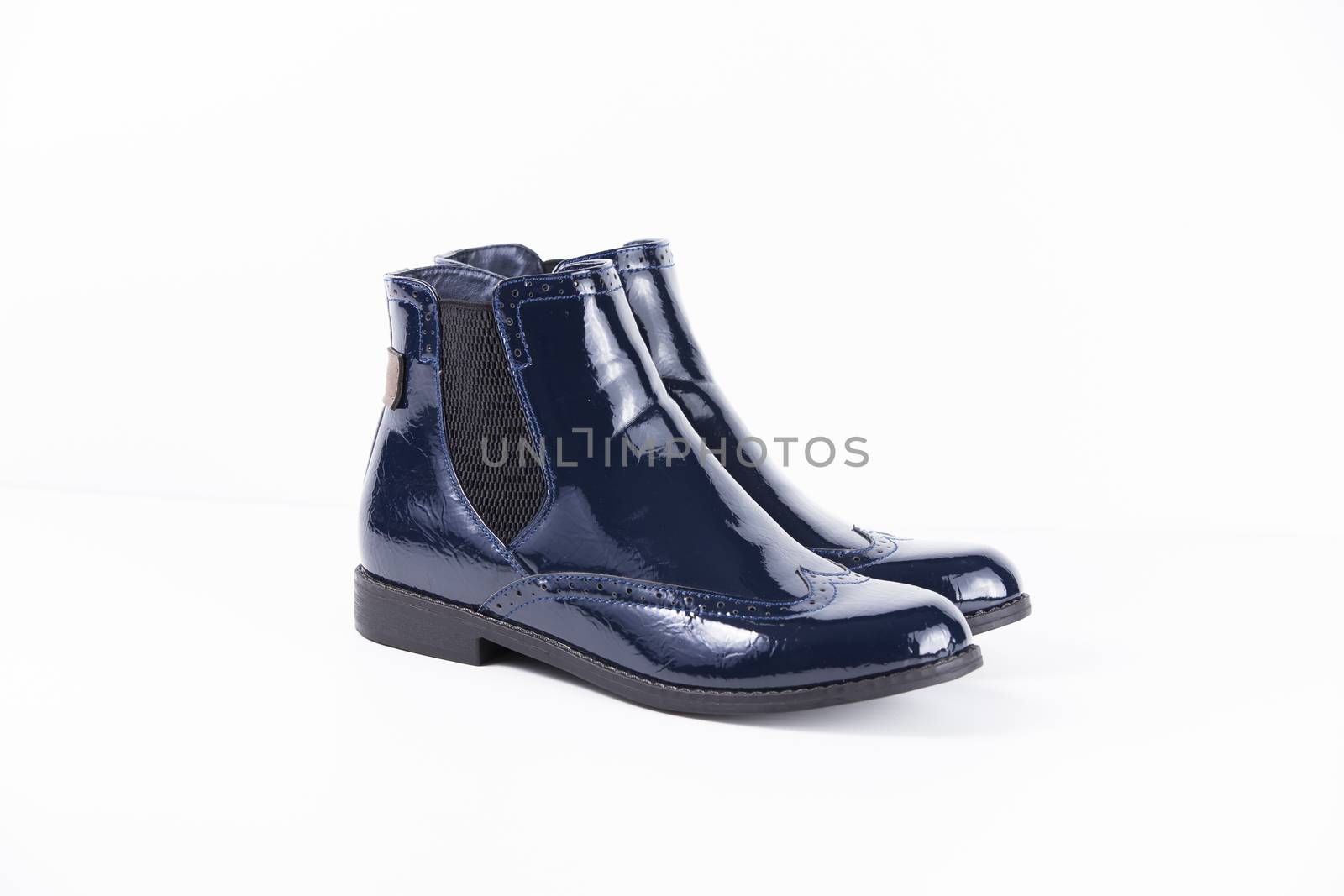 Pair of blue leather boots on white background, isolated product.