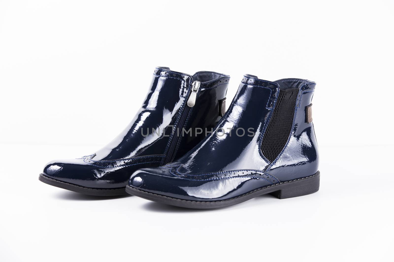 Pair of blue leather boots on white background, isolated product.