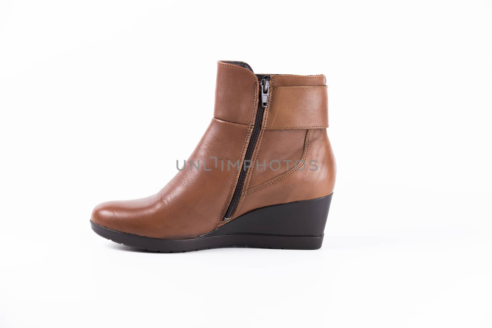 Brown leather boot on white background, isolated product.