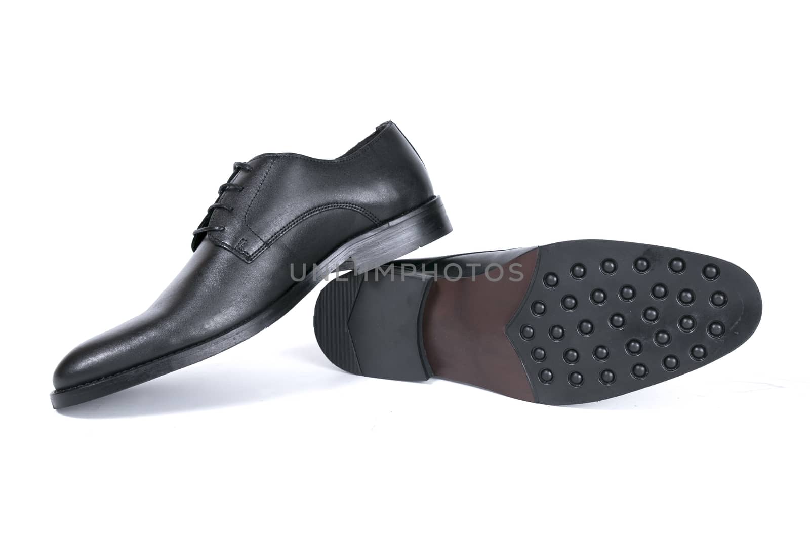 Pair of black shoes on white background, isolated product.