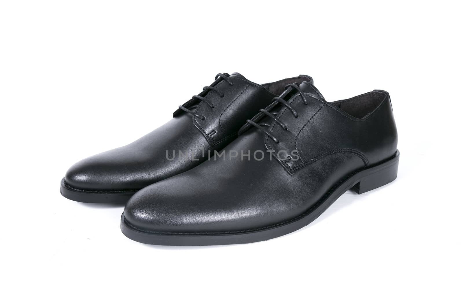 Pair of black shoes on white background, isolated product.