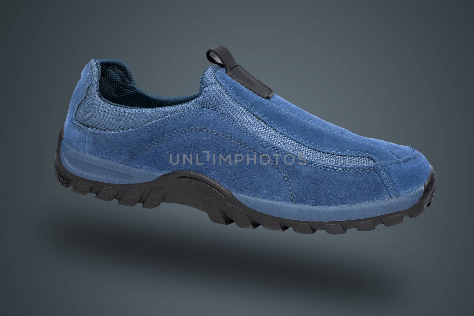 Blue shoe on blue background, isolated product.