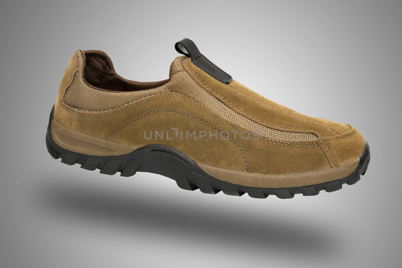 Brown shoe on grey background, isolated product.