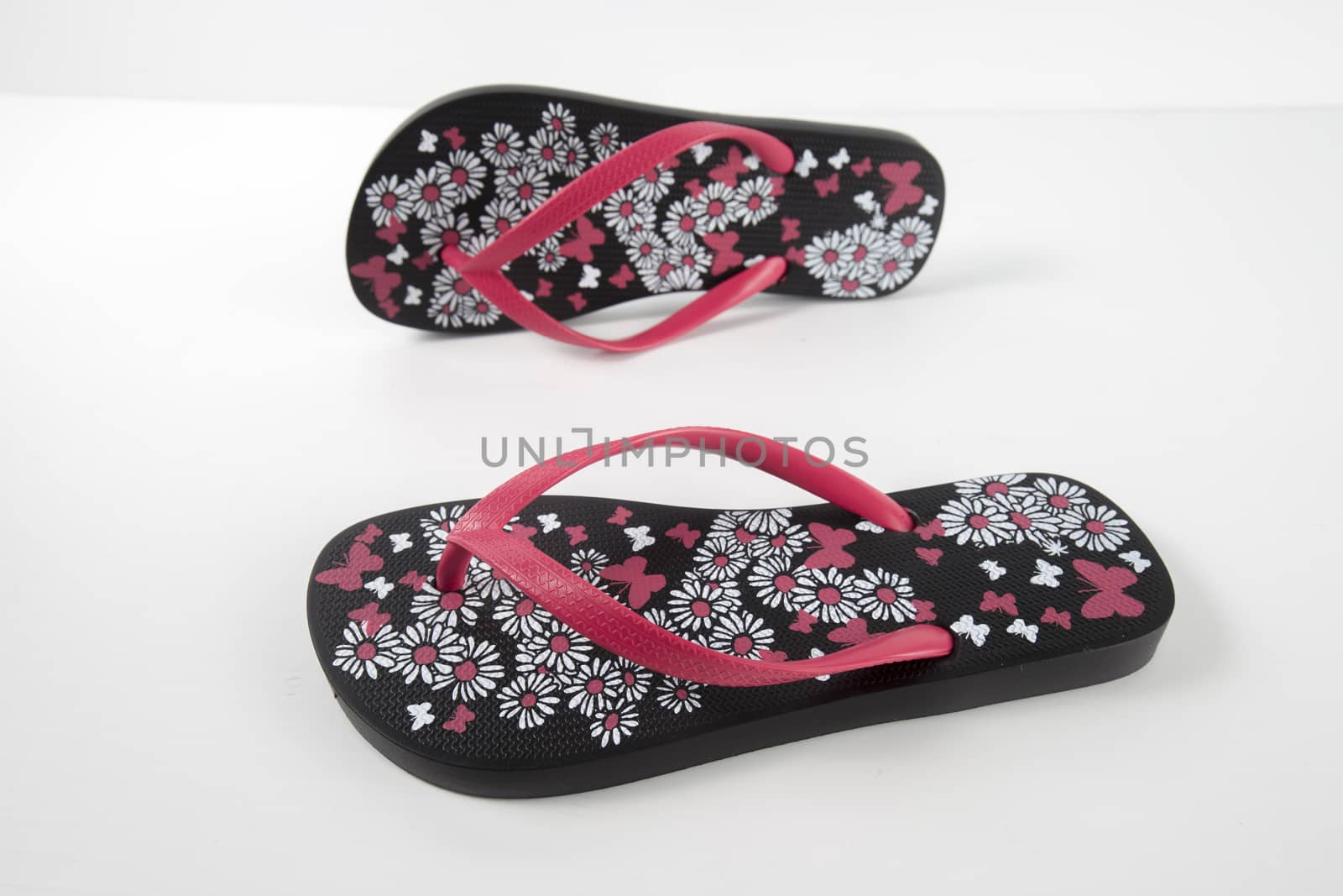 Black and pink rubber slipper on white background, isolated product.