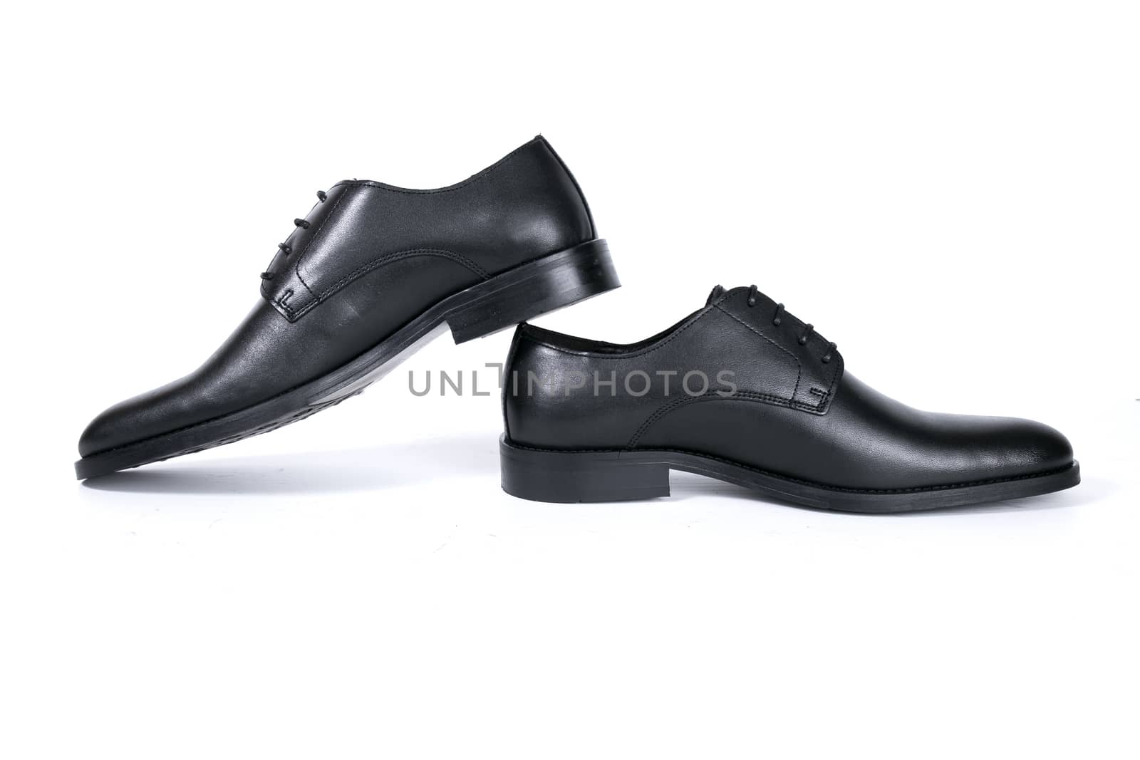 Pair of black shoes on white background, isolated product.