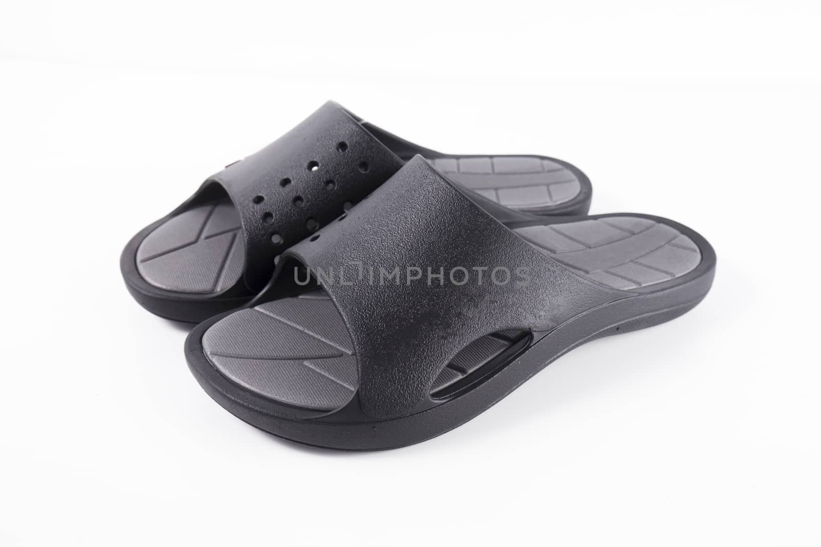 Pair of black slipper on white background, isolated product.