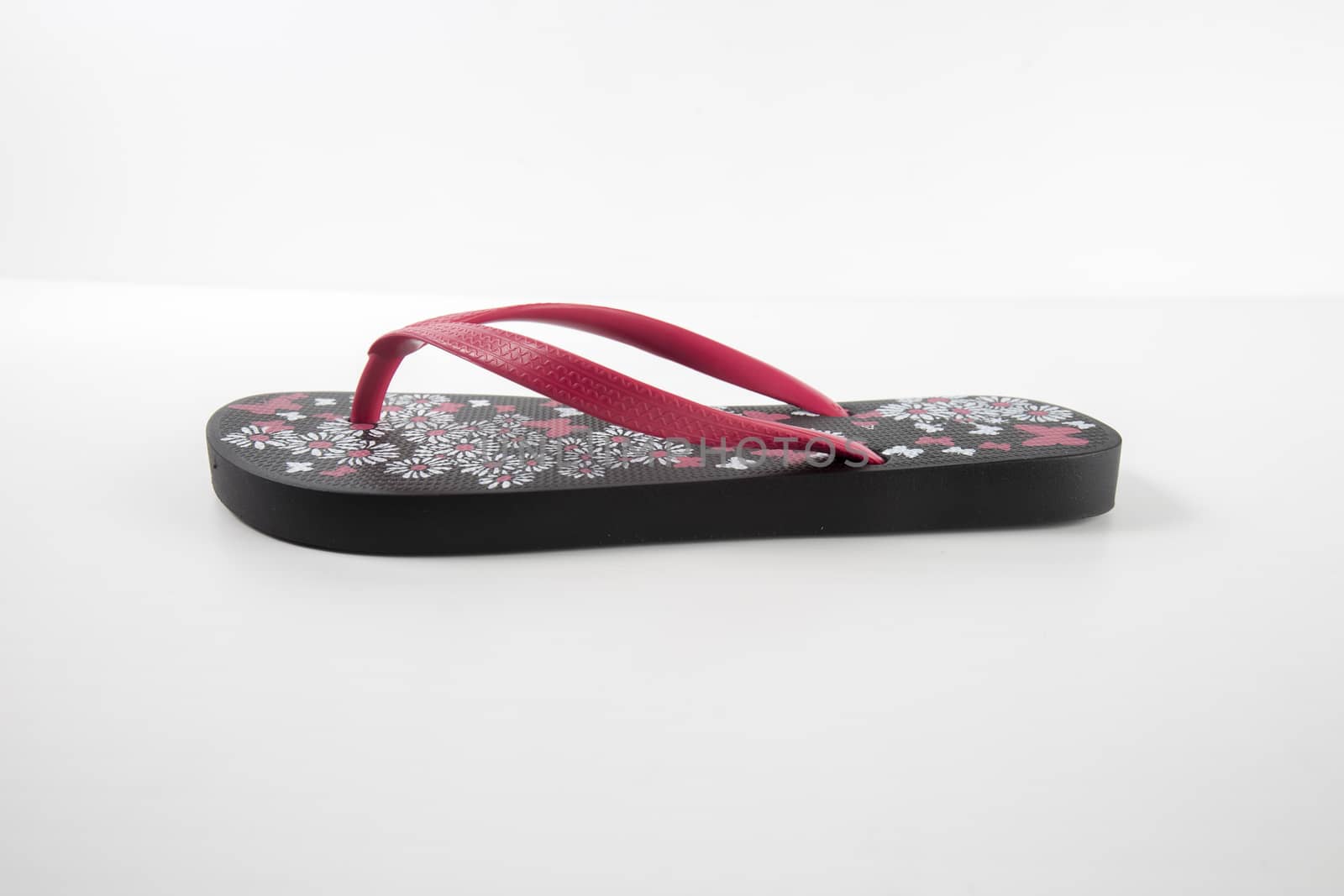 Black and pink rubber slipper on white background, isolated product. by GeorgeVieiraSilva