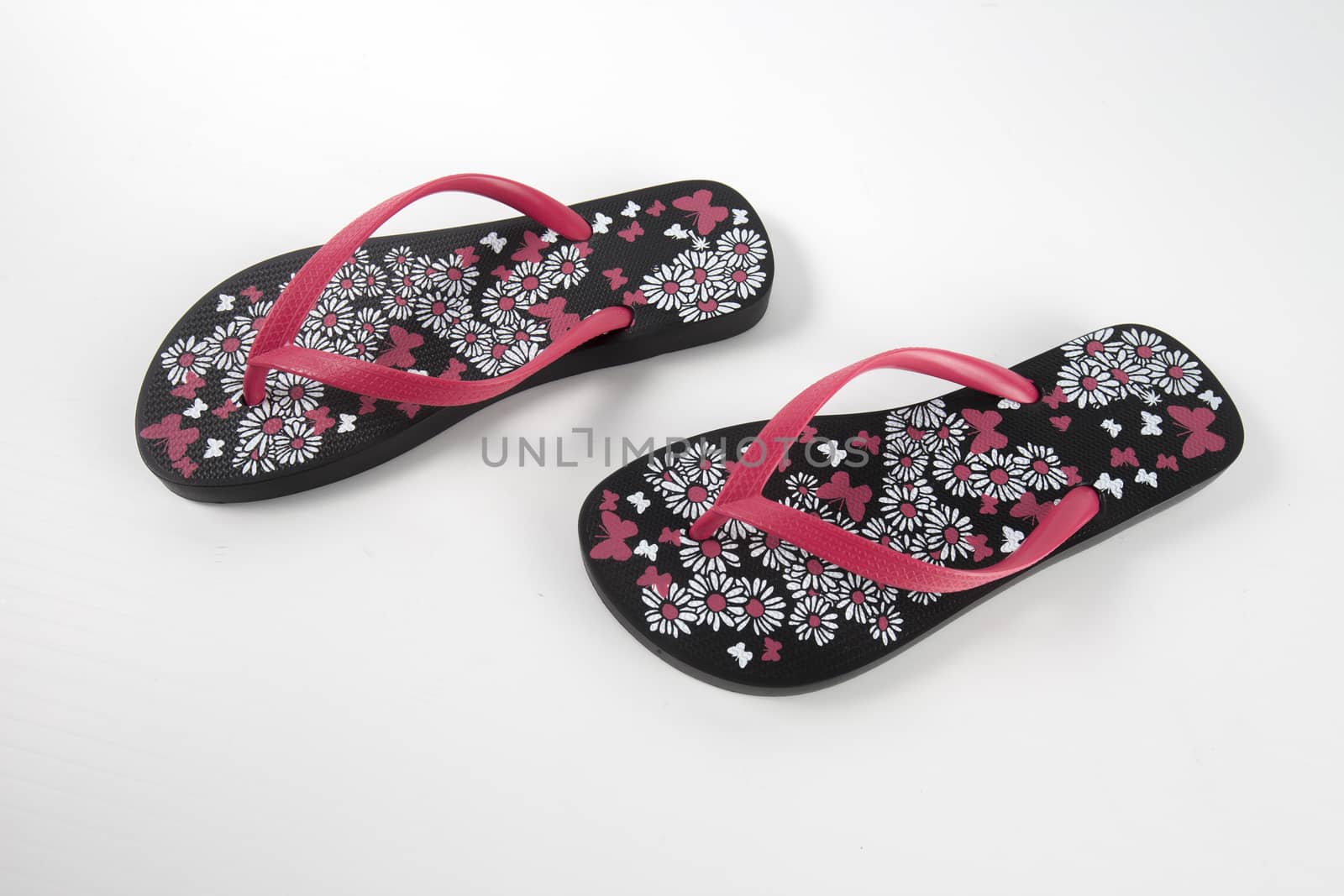 Black and pink rubber slipper on white background, isolated product. by GeorgeVieiraSilva