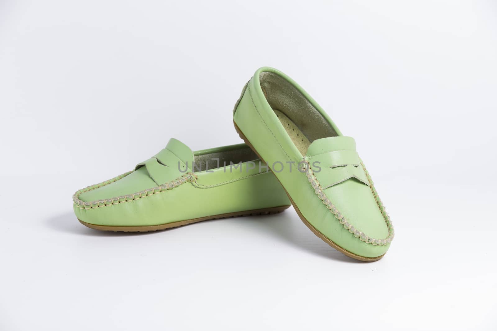 Pair of green leather shoes on white background, isolated product.