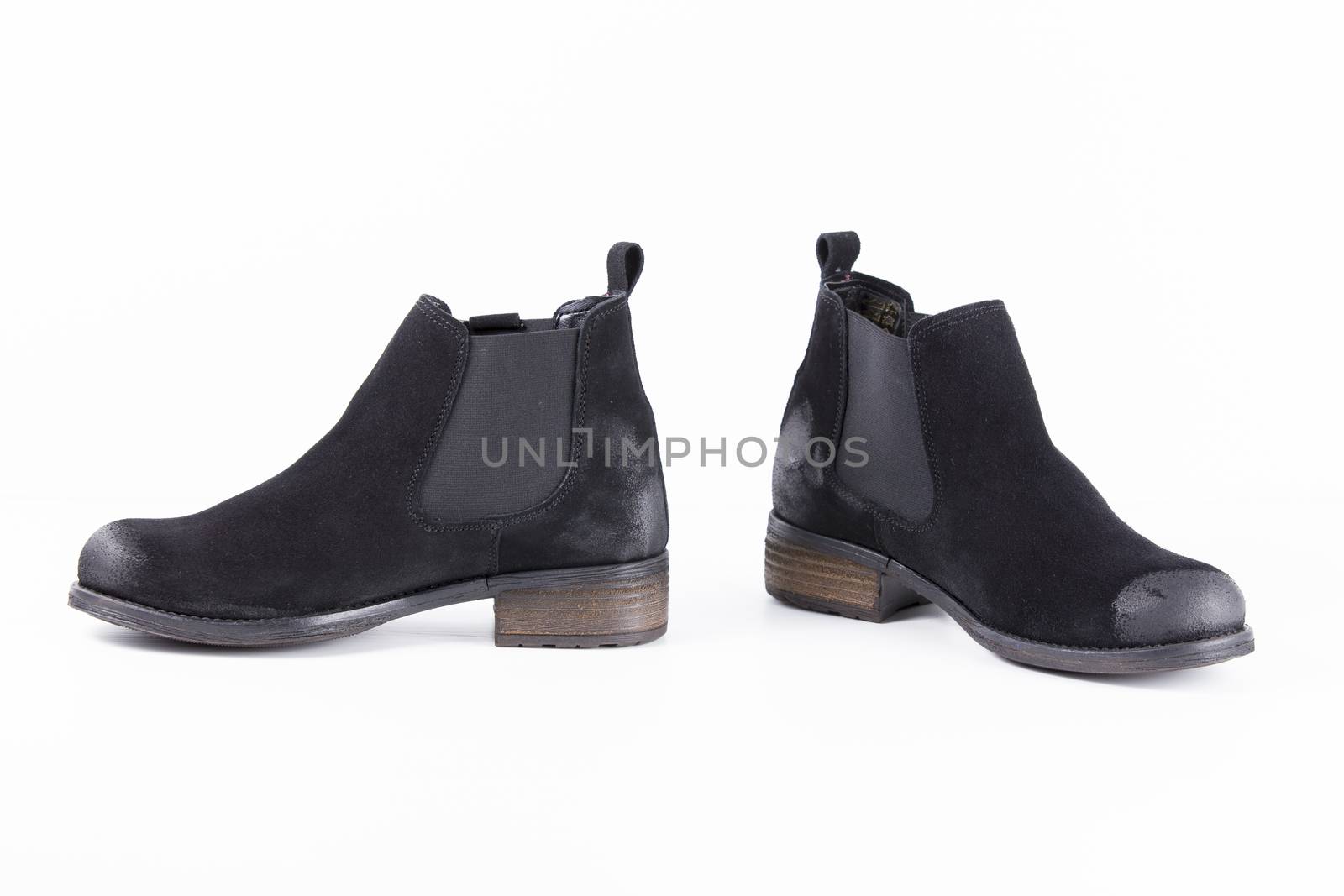 Pair of black leather boots on white background, isolated product.