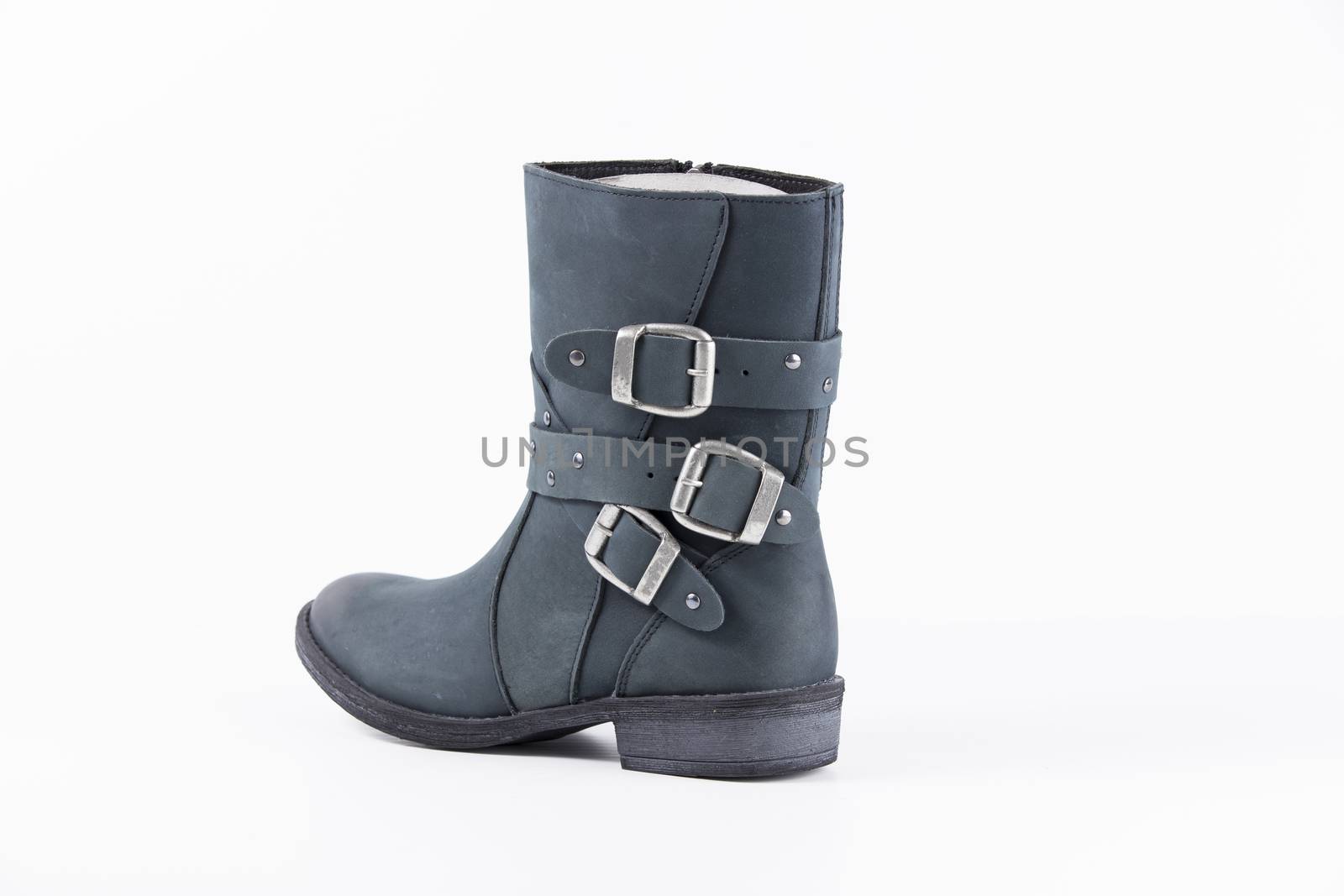 Female blue leather boots, isolated product.