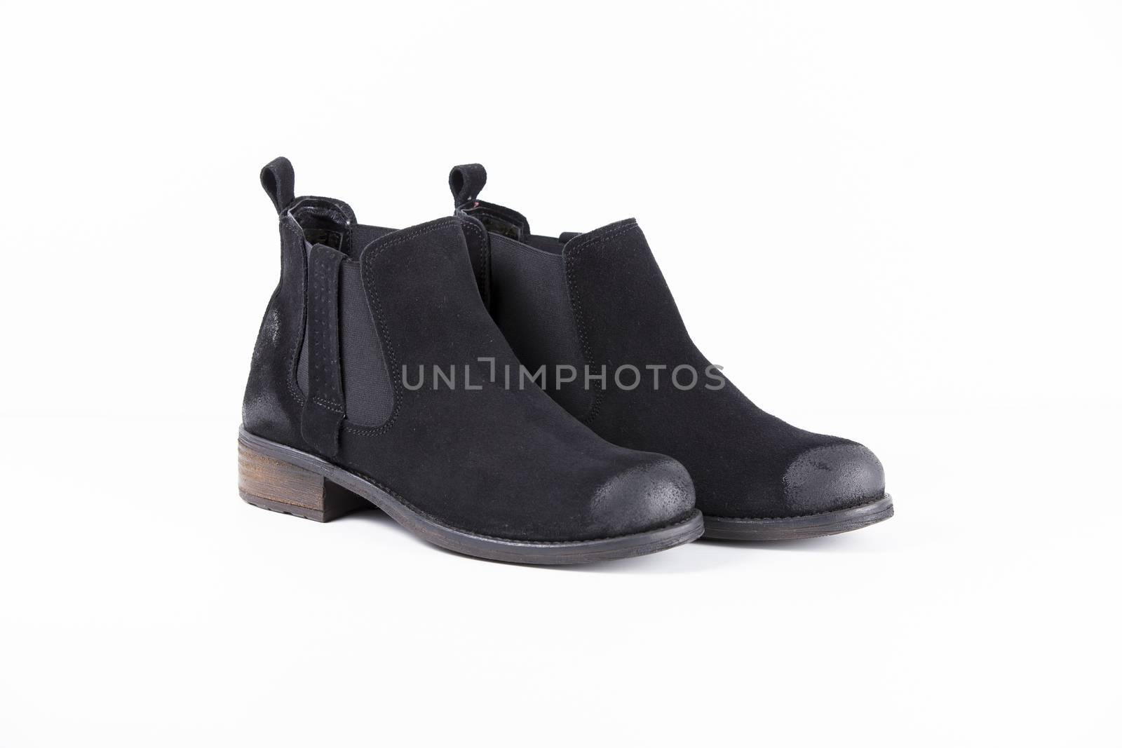 Pair of black leather boots on white background, isolated product.