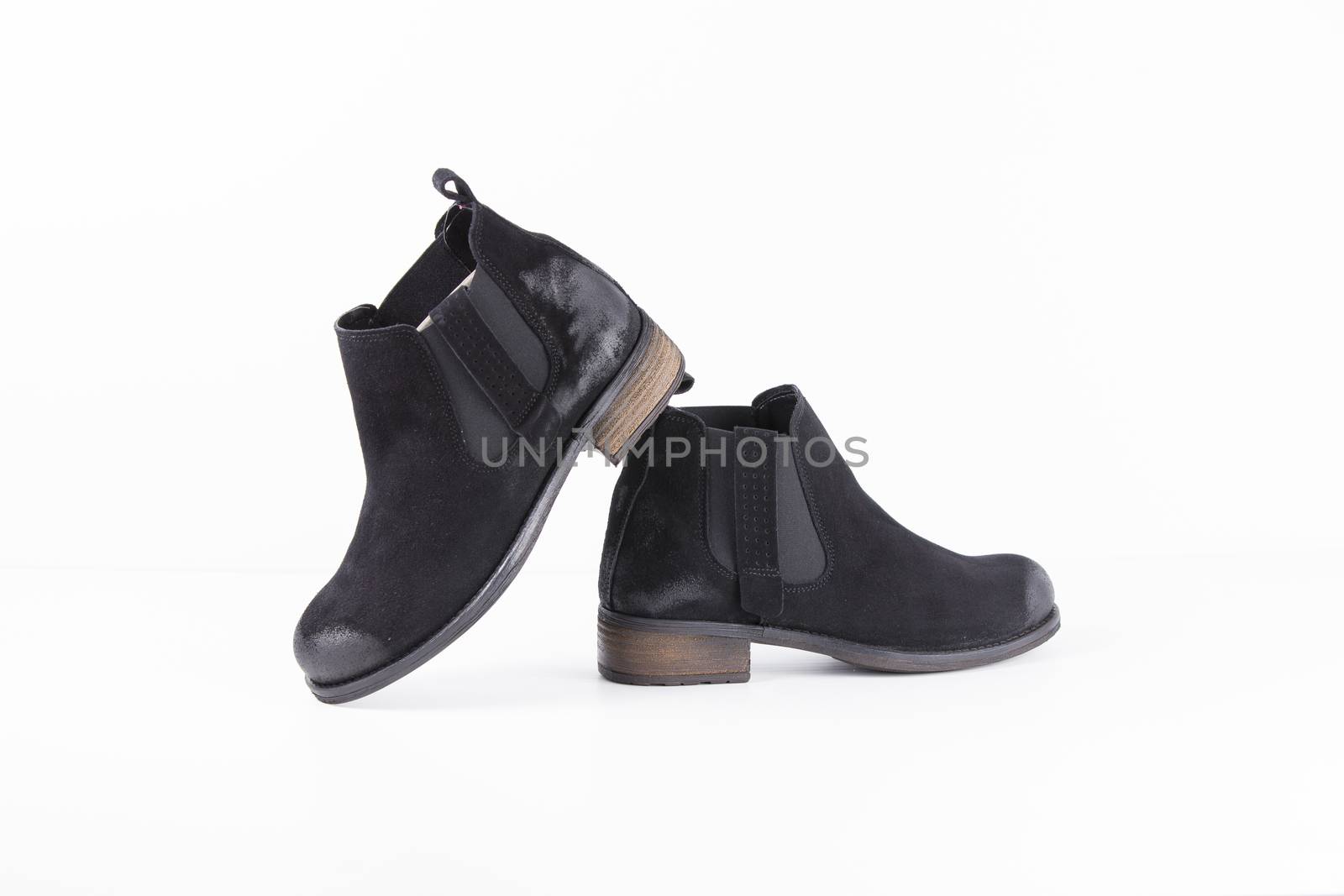 Pair of black leather boots on white background, isolated product. by GeorgeVieiraSilva