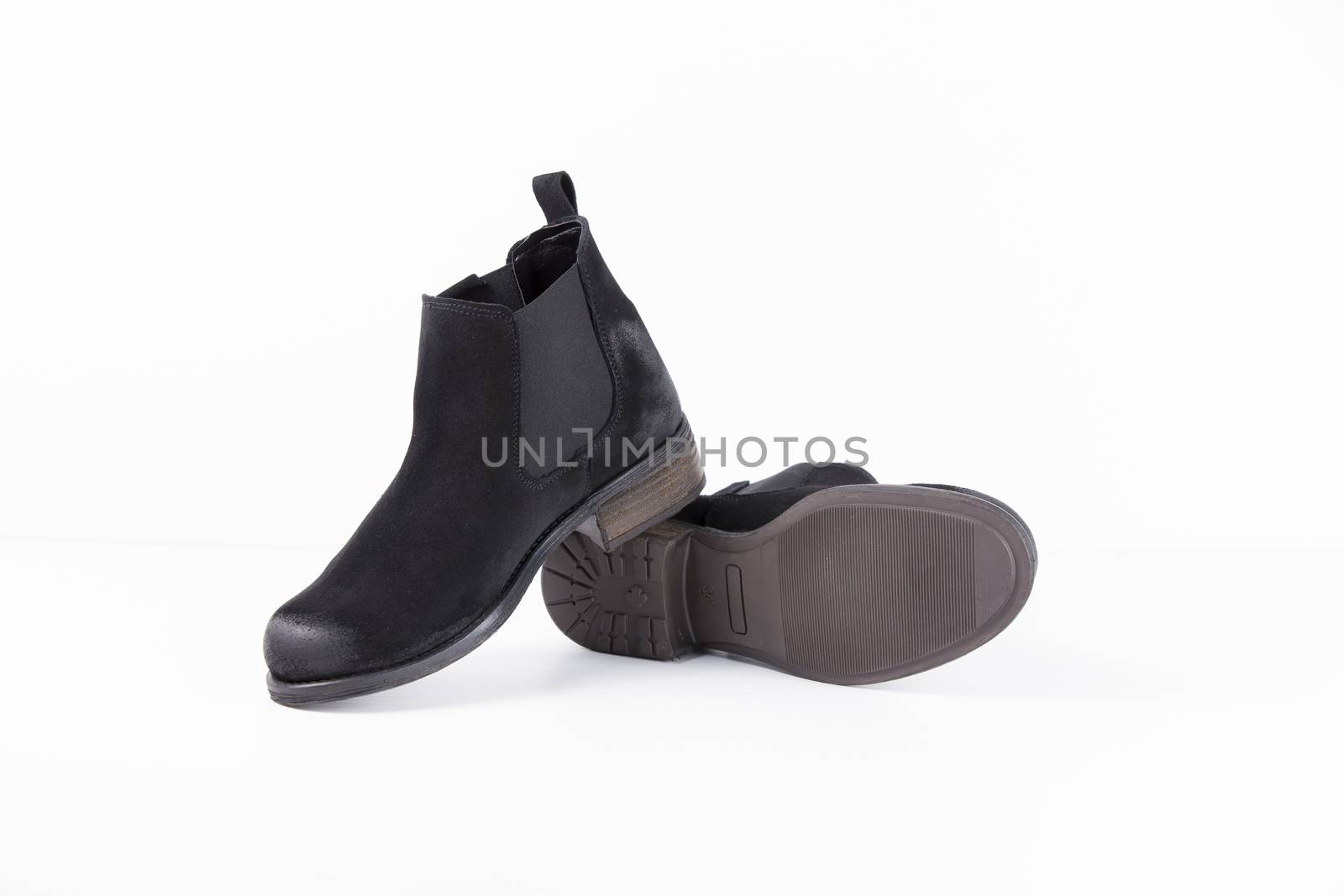 Pair of black leather boots on white background, isolated product. by GeorgeVieiraSilva