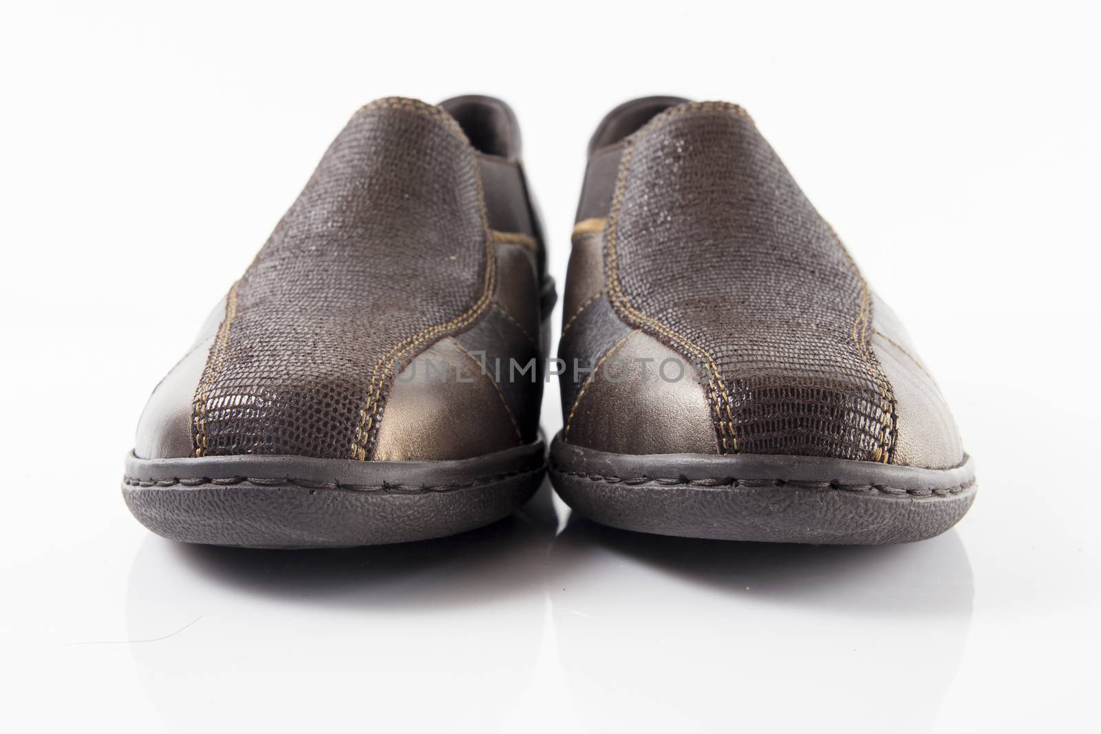 Pair of brown leather shoes on white background, isolated product, top view.