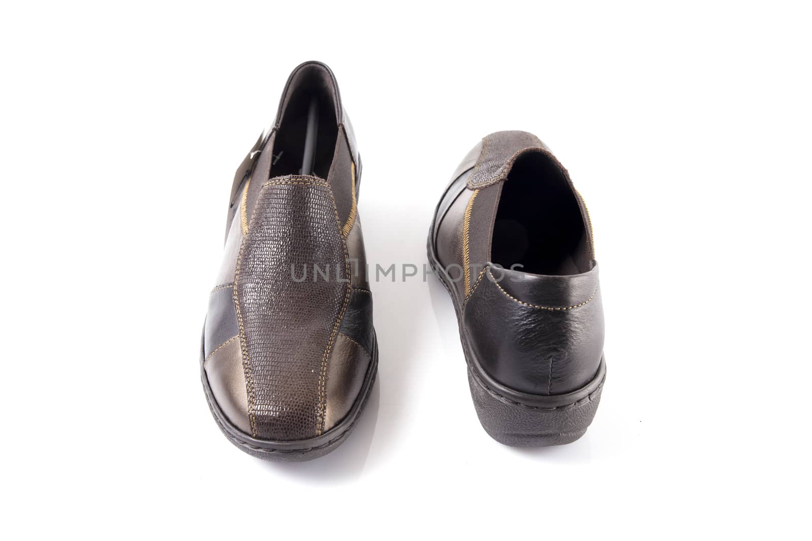 Pair of brown leather shoes on white background, isolated product, top view.