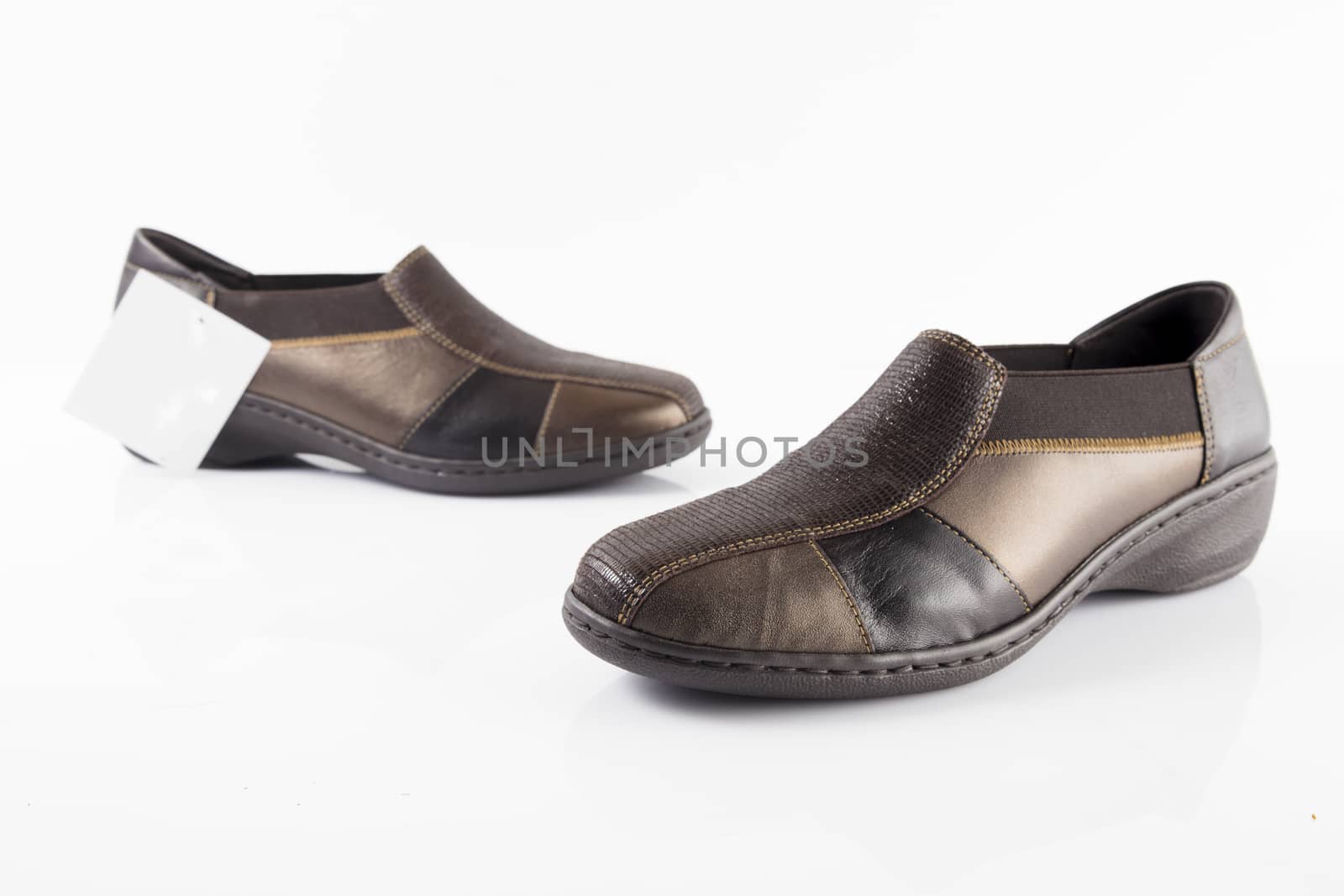 Pair of brown leather shoes on white background, isolated product, top view.