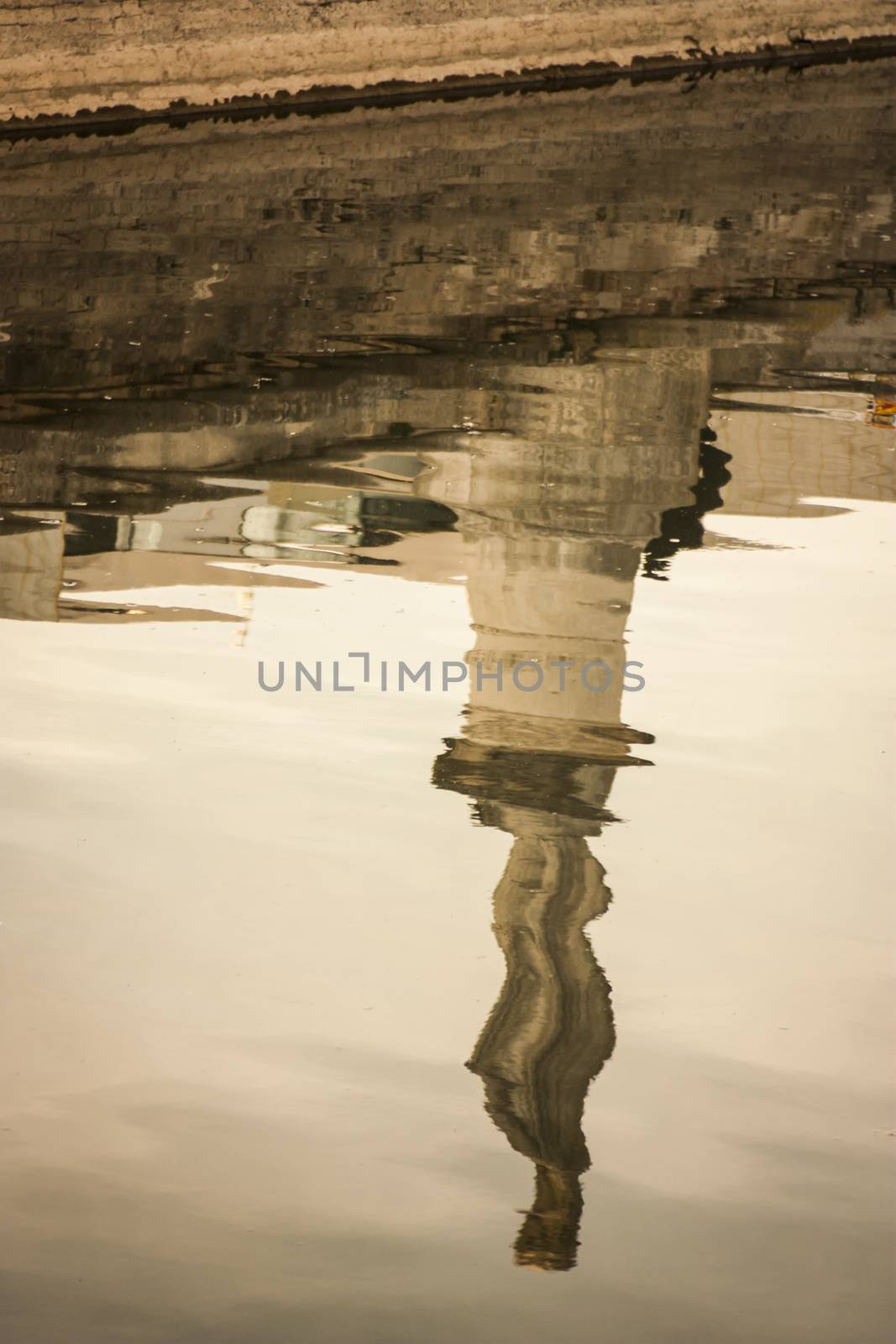 A beautiful water reflection of a historical monument in a typical Italian city. Artistic photo.