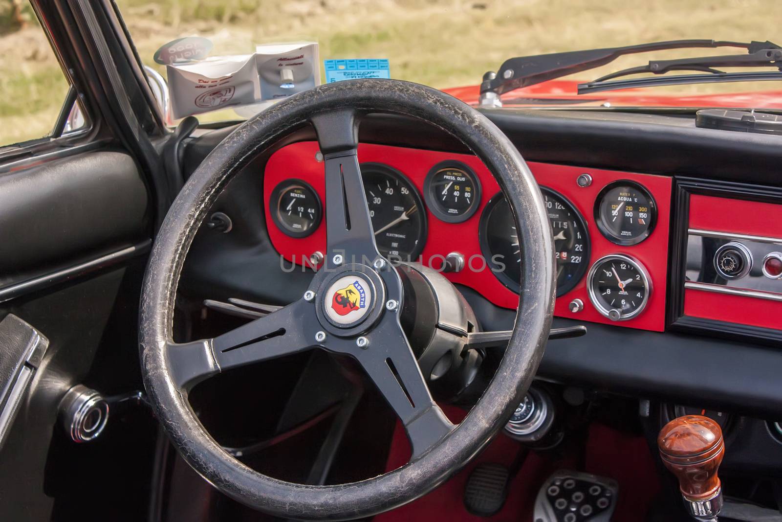Interior of a Fiat Abarth historic resumption of the dashboard details and the sports steering wheel. A beautiful Italian historical cars.