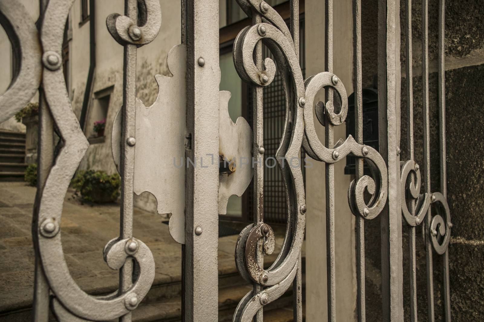 Detail of a lock of an old wrought iron gates worked by hand.