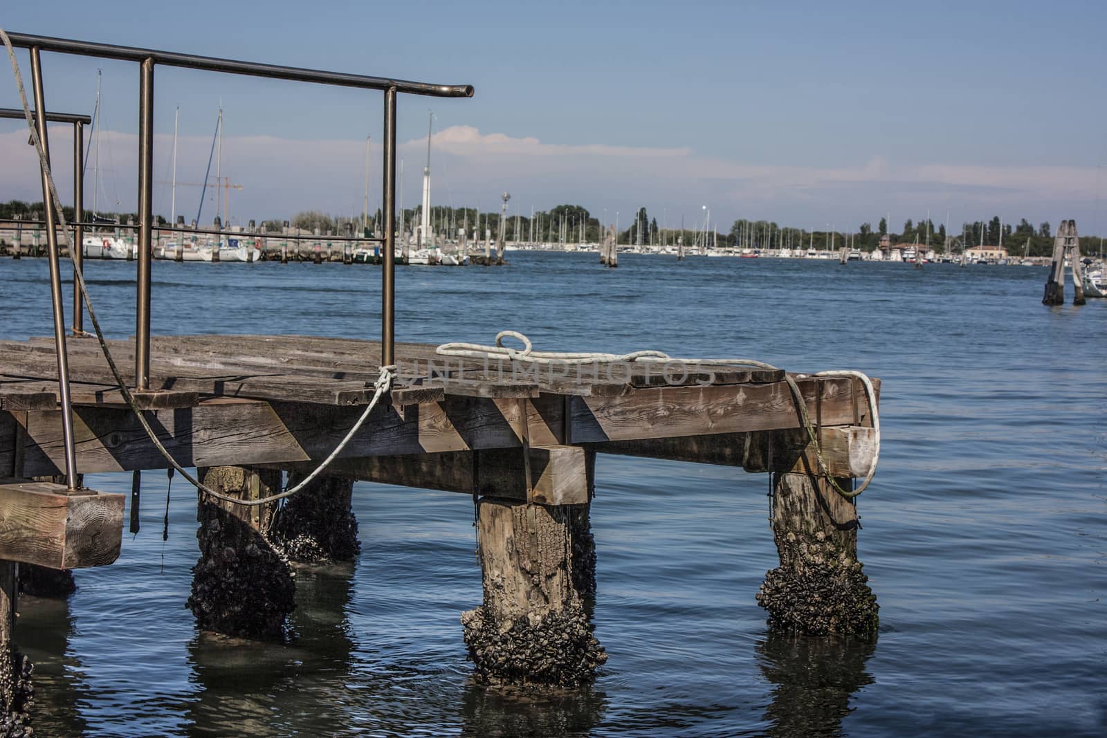 Small wooden mooring for medium and small boats on the Venice lagoon.