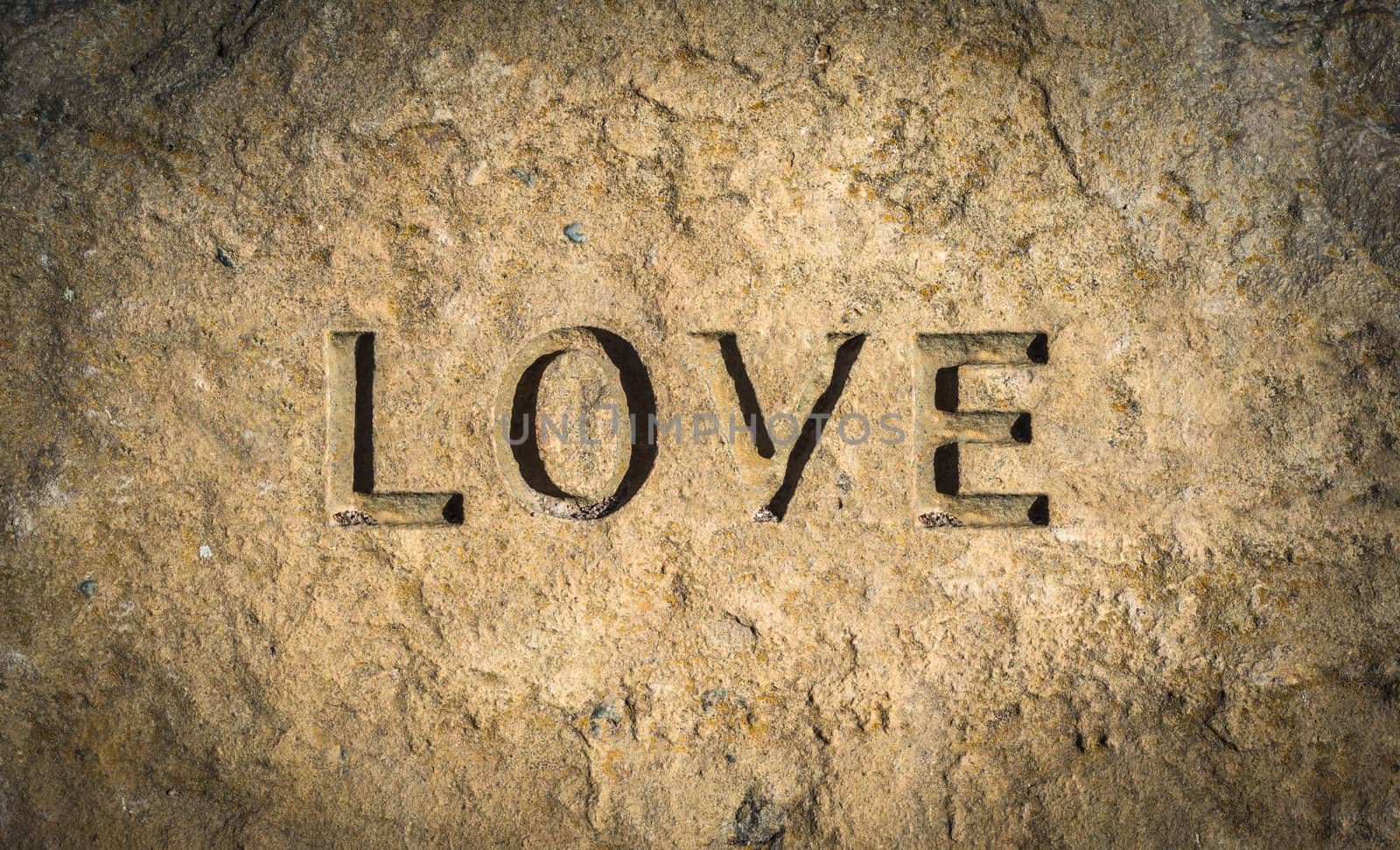 Conceptual Image Of The Word Love Chiseled Into Stone Or Rock